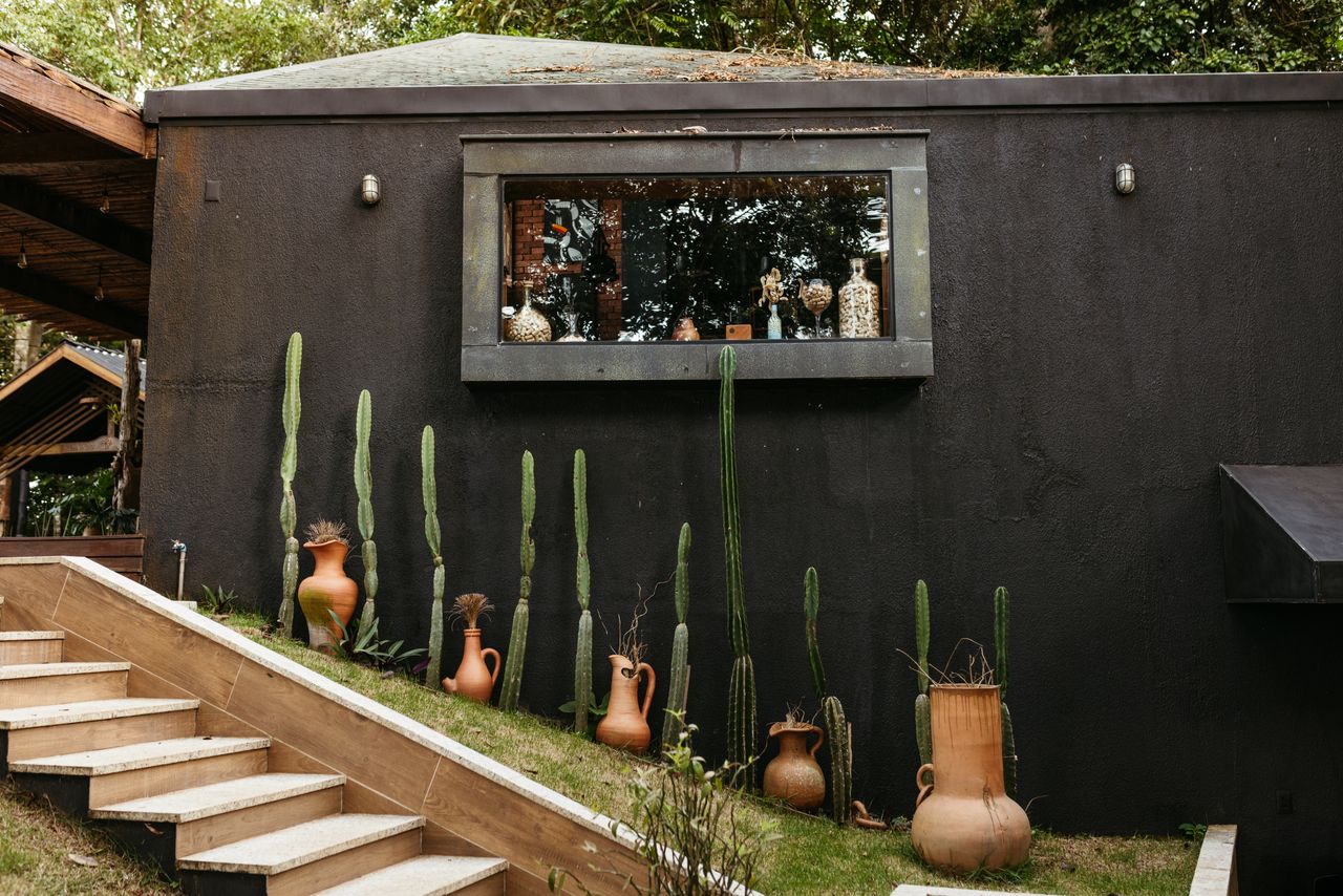Casa de campo moderna envolta por gramado e árvores